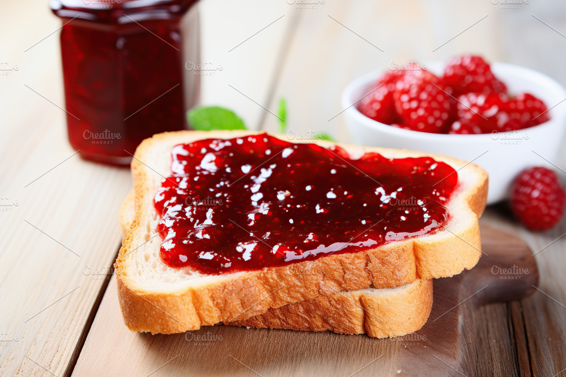Toasted bread with sweet jam on wooden background, a Food & Drink Photo by AlyaAnd