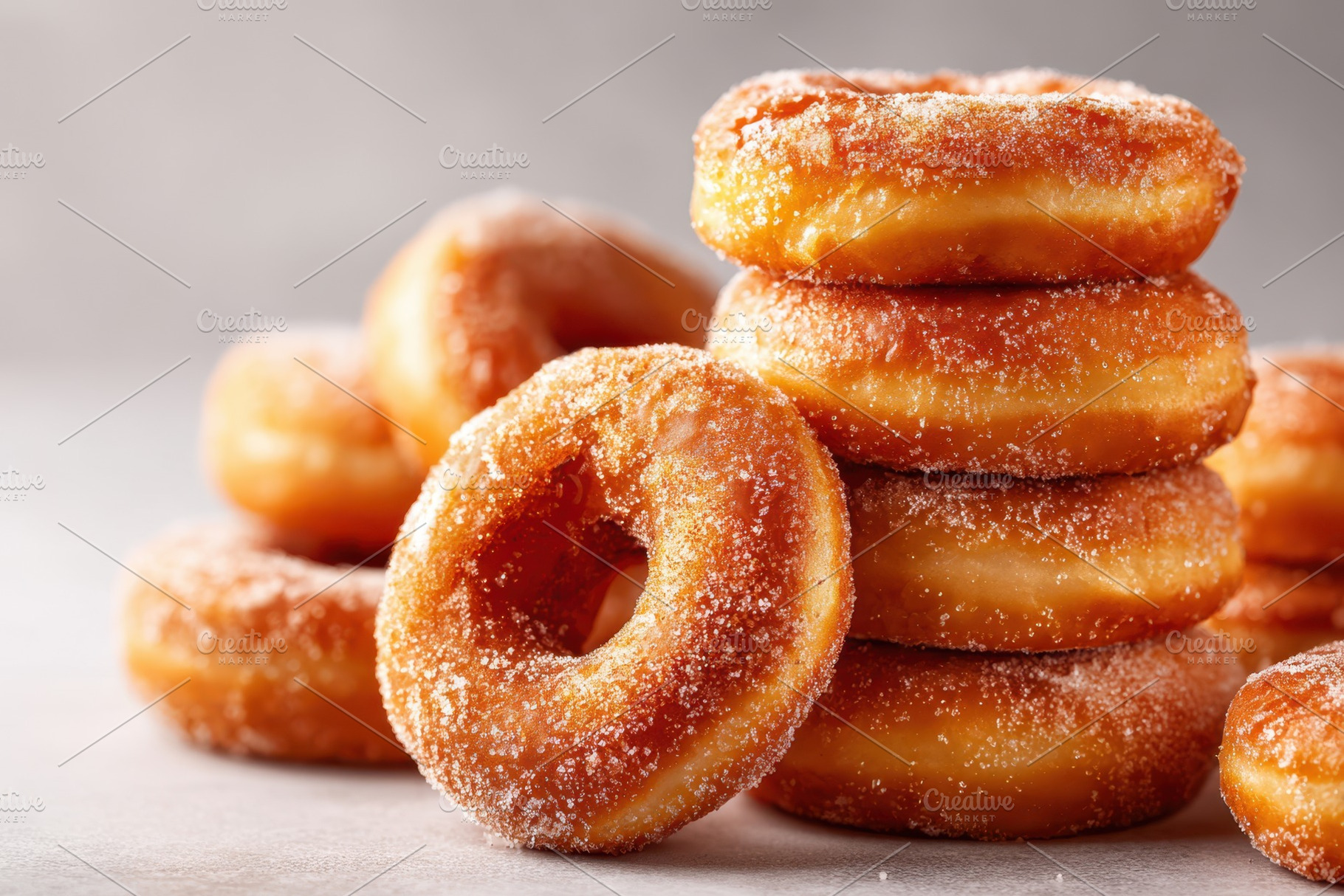 Stack of sugar-coated ring donuts, a Food & Drink Photo by AlyaAnd