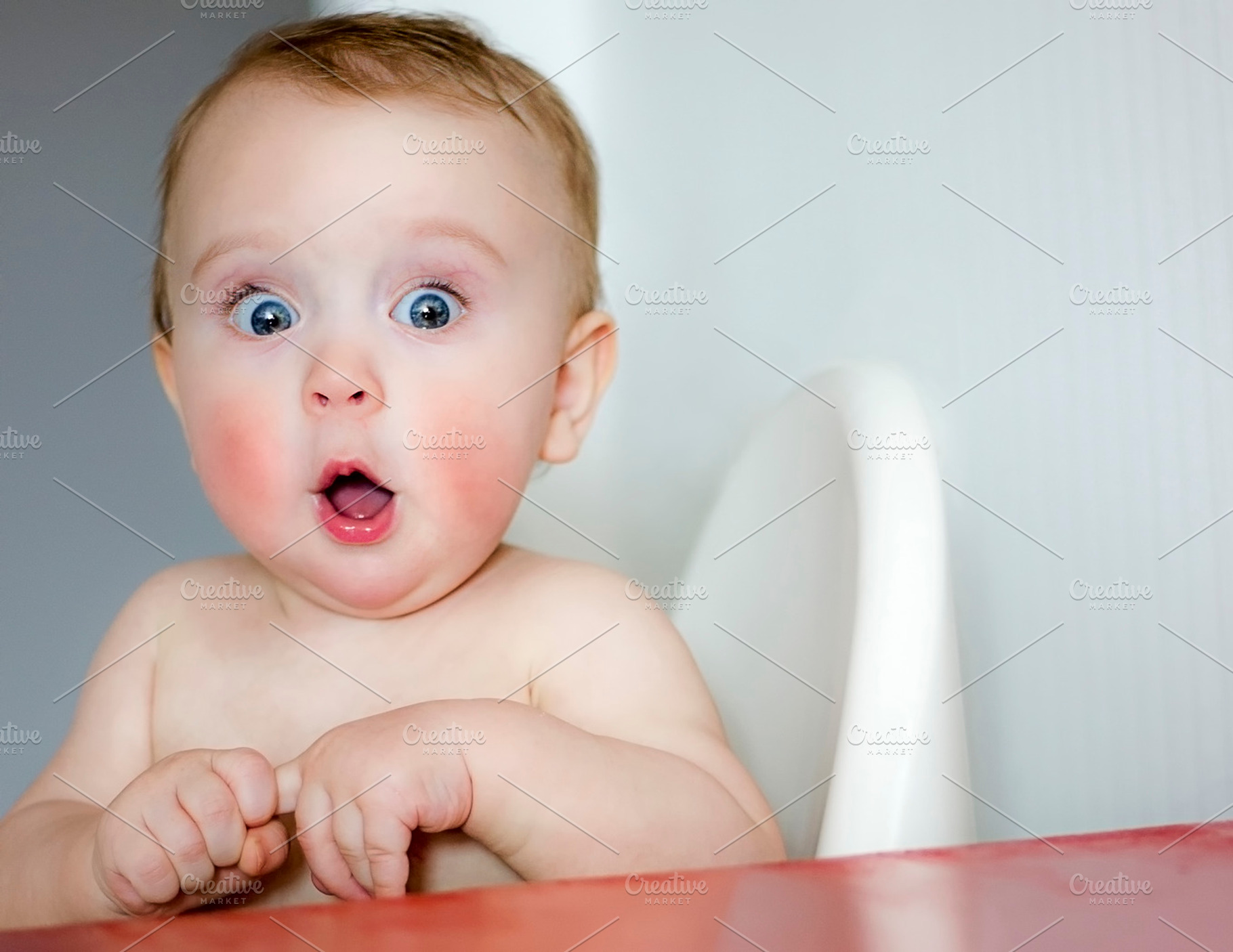 surprised kid sitting at table, a Person Photo by EvgeniiAnd