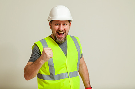 worker in a vest and white helmet, a Person Photo by Photostock