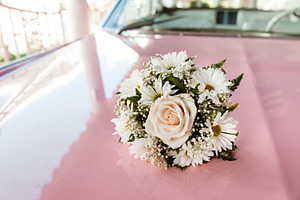 Wedding Bouquet On The Top Of Car