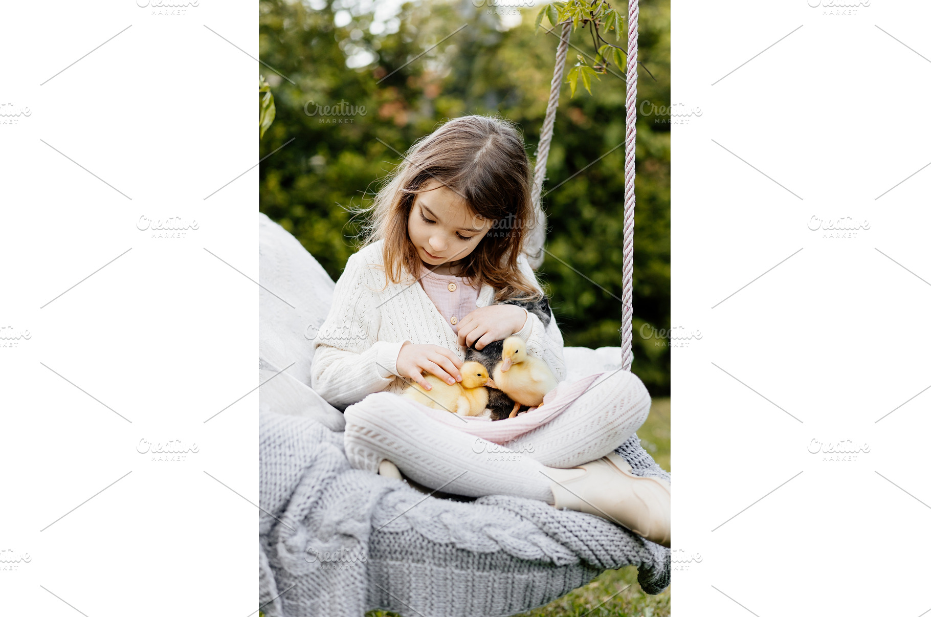 Girl sitting on swing with baby, an Animal Photo by HalfPoint