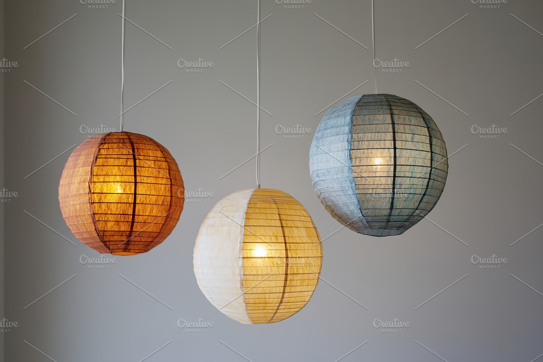 Chinese paper lanterns on grey background, a Photo by AlyaAnd