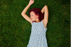 Teen girl relaxes on green grass in, a Nature Photo by IlliaBondarPhotography