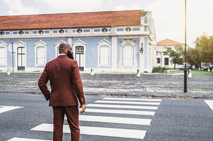 An African man on the crosswalk, a Person Photo by SkyNext