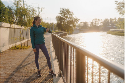 Young woman runner checking her, a Sports & Recreation Photo by HalfPoint