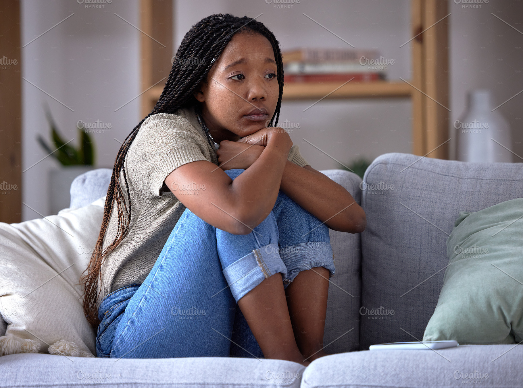 Sad, depression and lonely black woman on sofa with mental health issue, problems and stress. Thinking, reflection and depressed girl sitting in living room with mistake, failure and negative emotion, a Photo by Peopleimages.com
