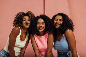 Three happy girls with curly hair, a Person Photo by Artem Varnitsin