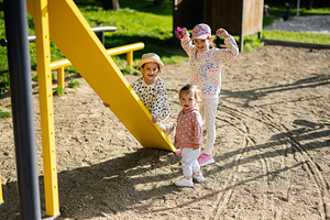 Children playing together outdoors at the playground on a sunny day, a Person Photo by AS photostudio