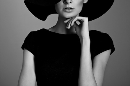 Woman retro fashion portrait containing black, white, and hat