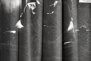 Man behind curtain in dramatic backlight, a Person Photo by DanFLCreativo