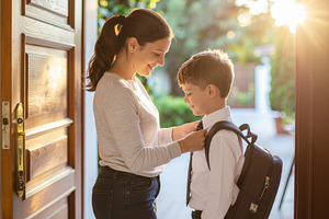 Parent helping child with backpack, a School & Education Photo by DanFLCreativo
