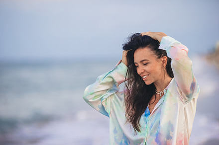 Portrait of young happy woman on the beach, a Person Photo by travnikovstudio
