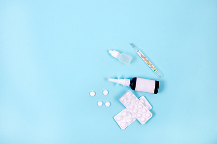 medicines, pills and thermometer on a blue background, Pharmaceu, a Health & Medical Photo by vimart