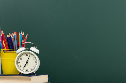 stack of books, a round alarm clock and multicolored pencils on, a School & Education Photo by ndanko