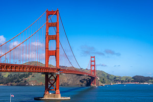 Golden Gate Bridge over blue waters with scenic hills in San Fra, a Photo by GoodGoods