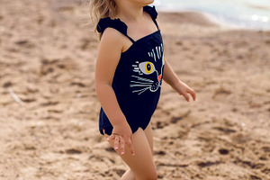 Little girl stands on the shore featuring child, shore, and kid