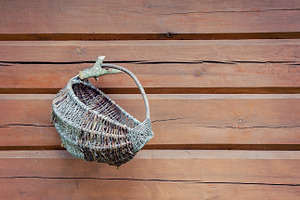 Wicker basket on wooden wall, an Industrial Photo by BOOCYS