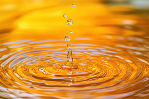 Water droplets create ripples on a s, a Photo by Tanuart