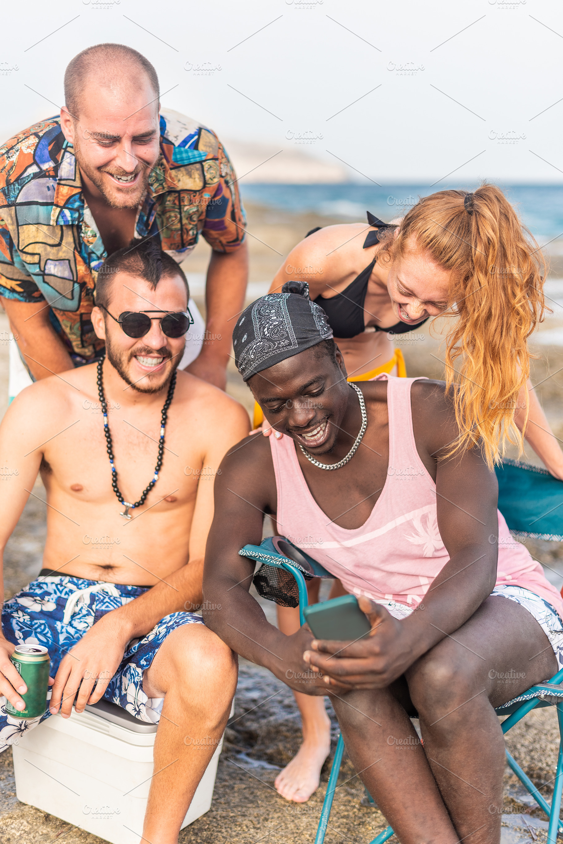 four multiracial friends having a good time at the beach, a Holiday Photo by Iván Moreno STOCK PHOTO