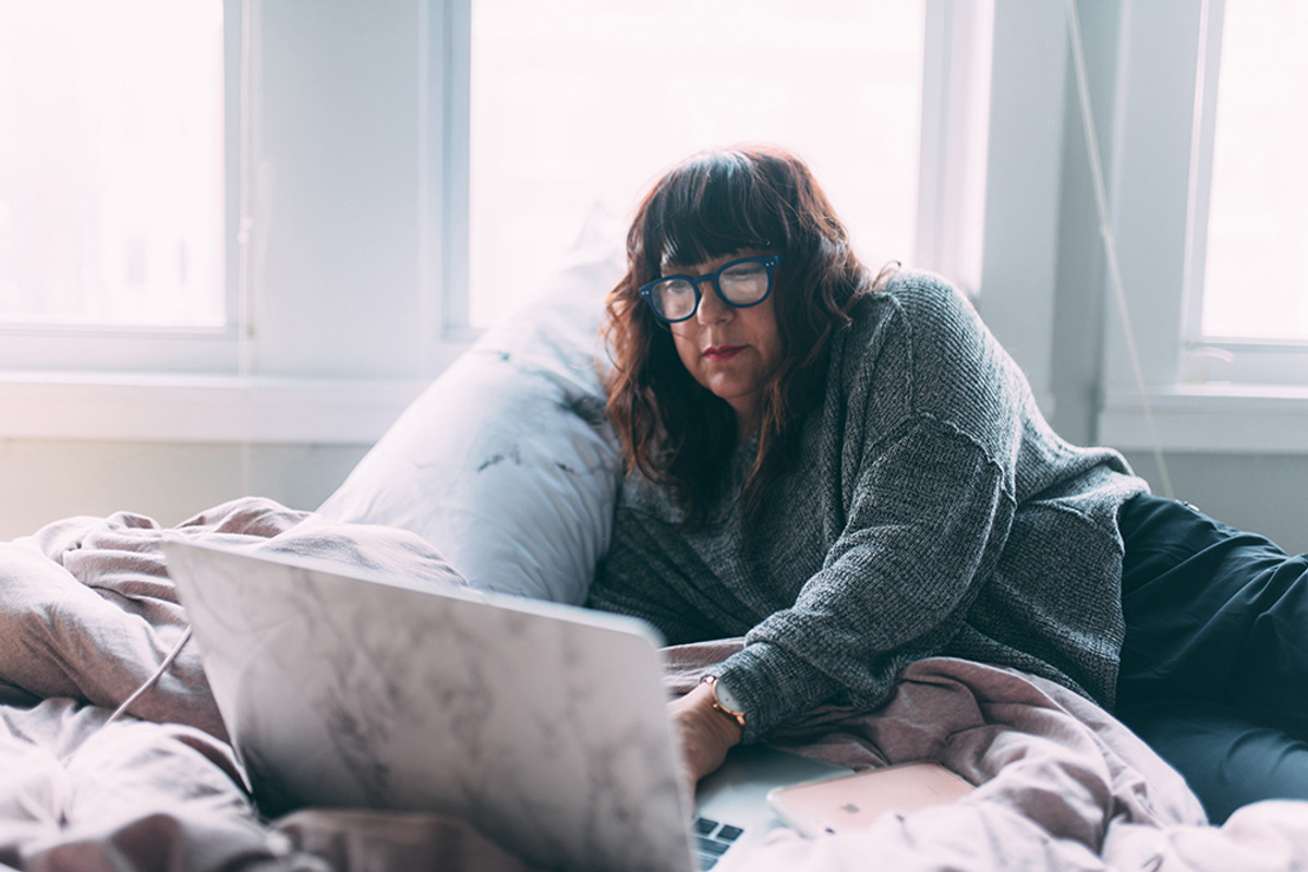 A woman in her 50s working from home containing woman, 50s, and older, a Person Photo by Chelsea Victoria (Photo 1 of 2)