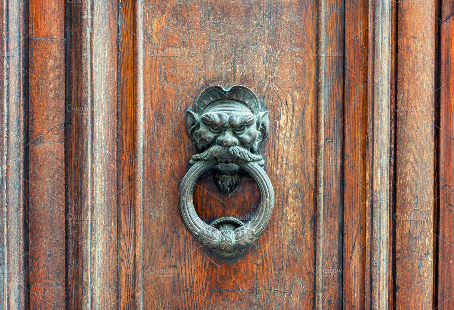 Iron lion doorknob on wooden door, an Architecture Photo by BOOCYS