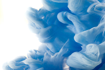 Blue clouds of ink in liquid isolated on white, an Abstract Photo by eleana