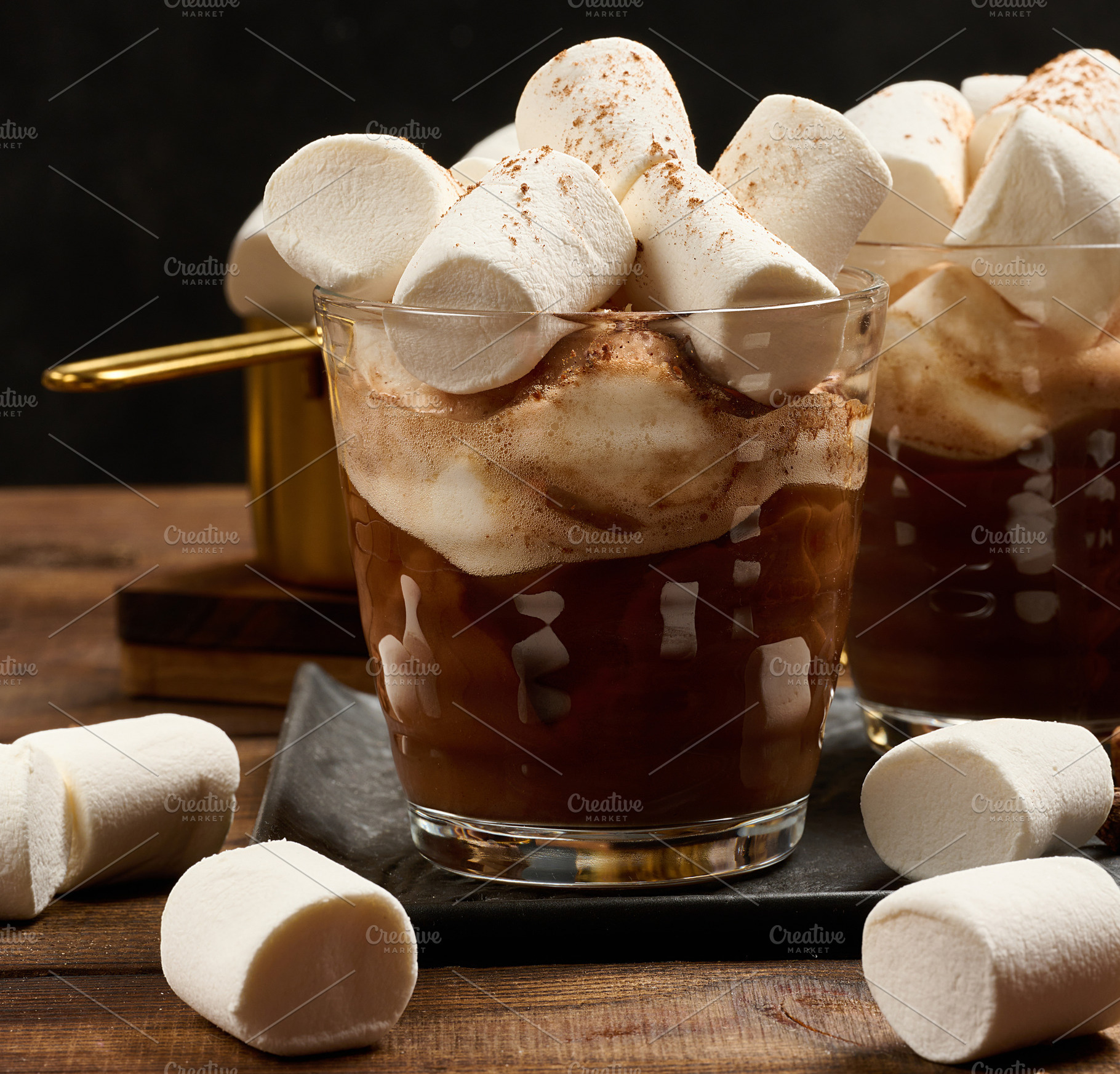 Two glasses of hot chocolate with fluffy marshmallows on a slate, a Food & Drink Photo by ndanko