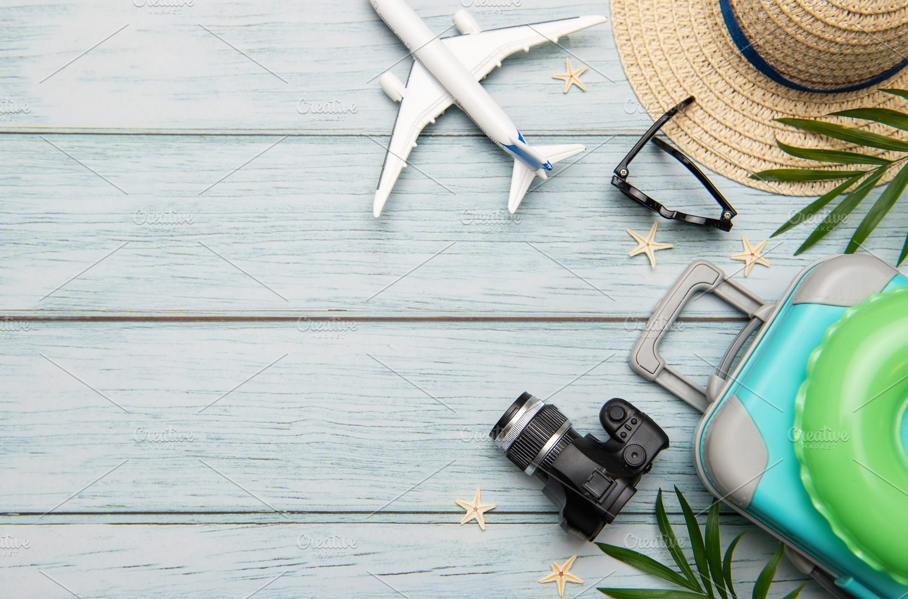 Travel accessories lying on wooden background for summer vacatio, a Holiday Photo by Olena Rudo