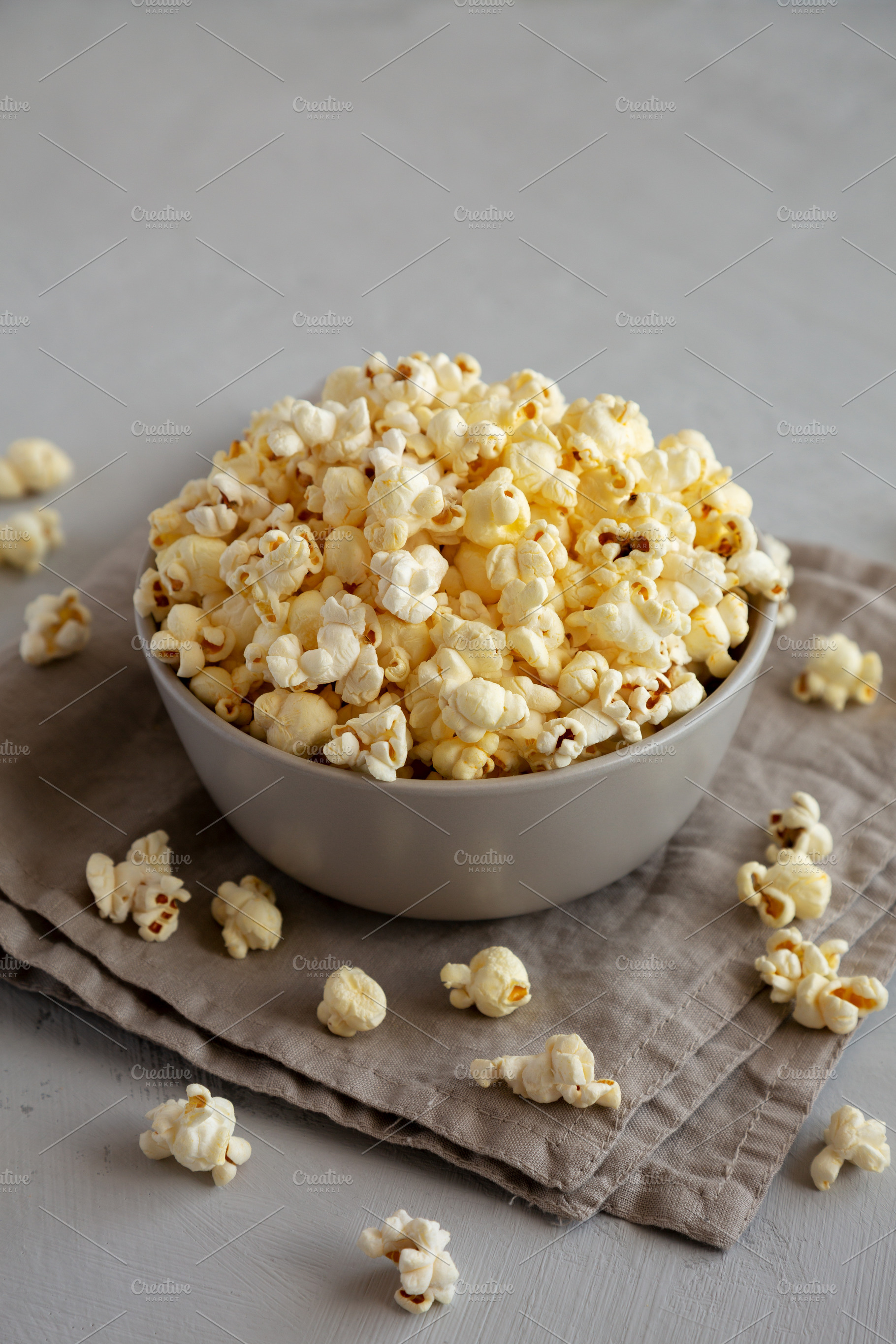 Homemade Salty Popcorn in a Bowl, side view., a Food & Drink Photo by LiudmylaChuhunova