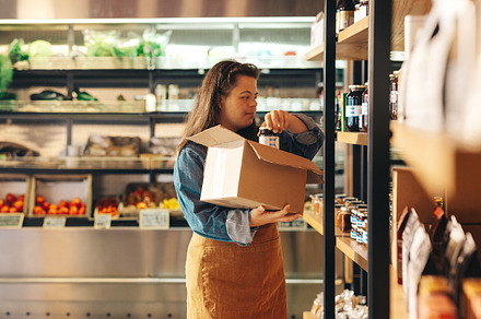 Supermarket worker with Down syndrome restocking food products, a Person Photo by Jacob Lund
