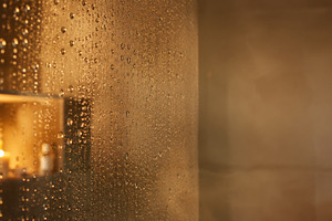 Dark showering concept. Steaming glass shower wall with blurred, a Photo by Dvoevnore photos