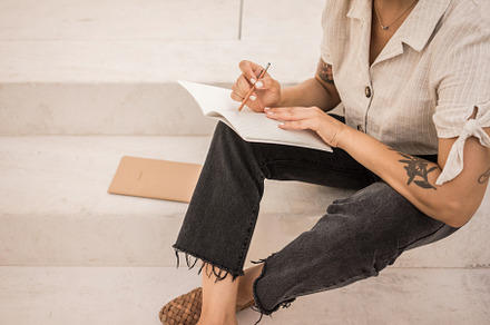 Girl writes notes in notebook stock photo containing girl and person, a School & Education Photo by Julia Brenner