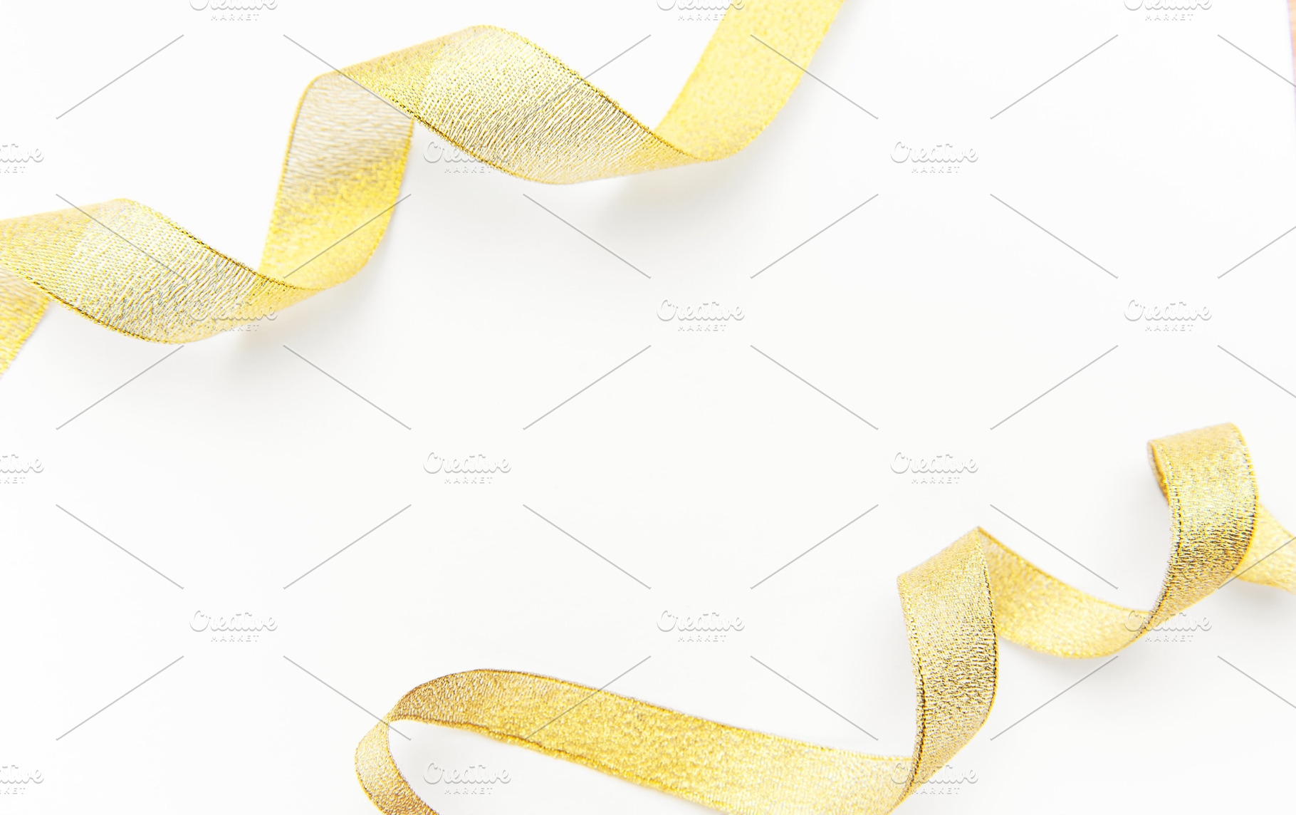 Gold glitter ribbon creating elegant border on white, a Holiday Photo by Olena Rudo