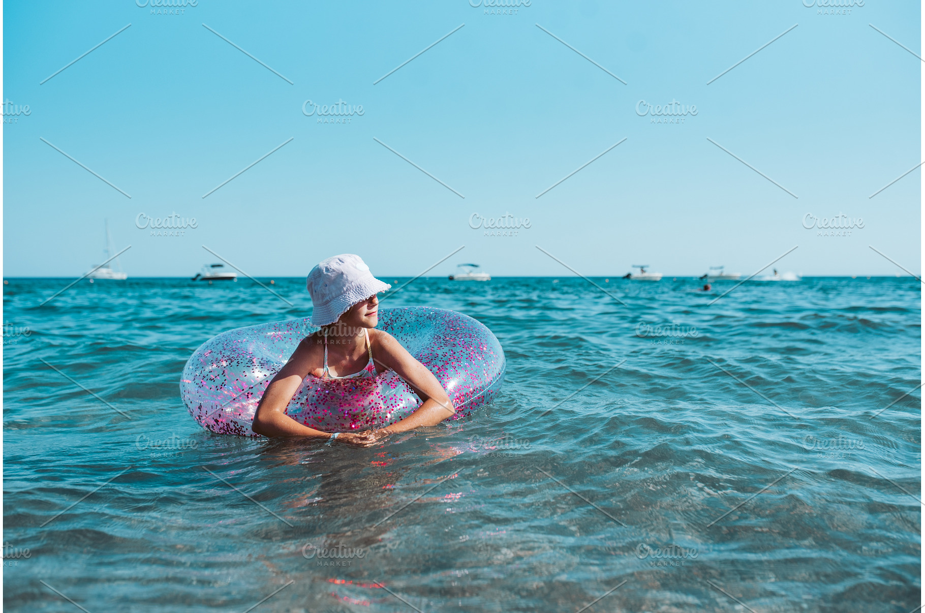 Girl on beach with swim ring during, a Sports & Recreation Photo by HalfPoint