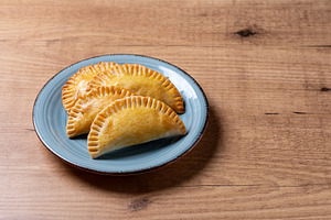 Golden baked empanadas served on a plate, a Food & Drink Photo by etorres69