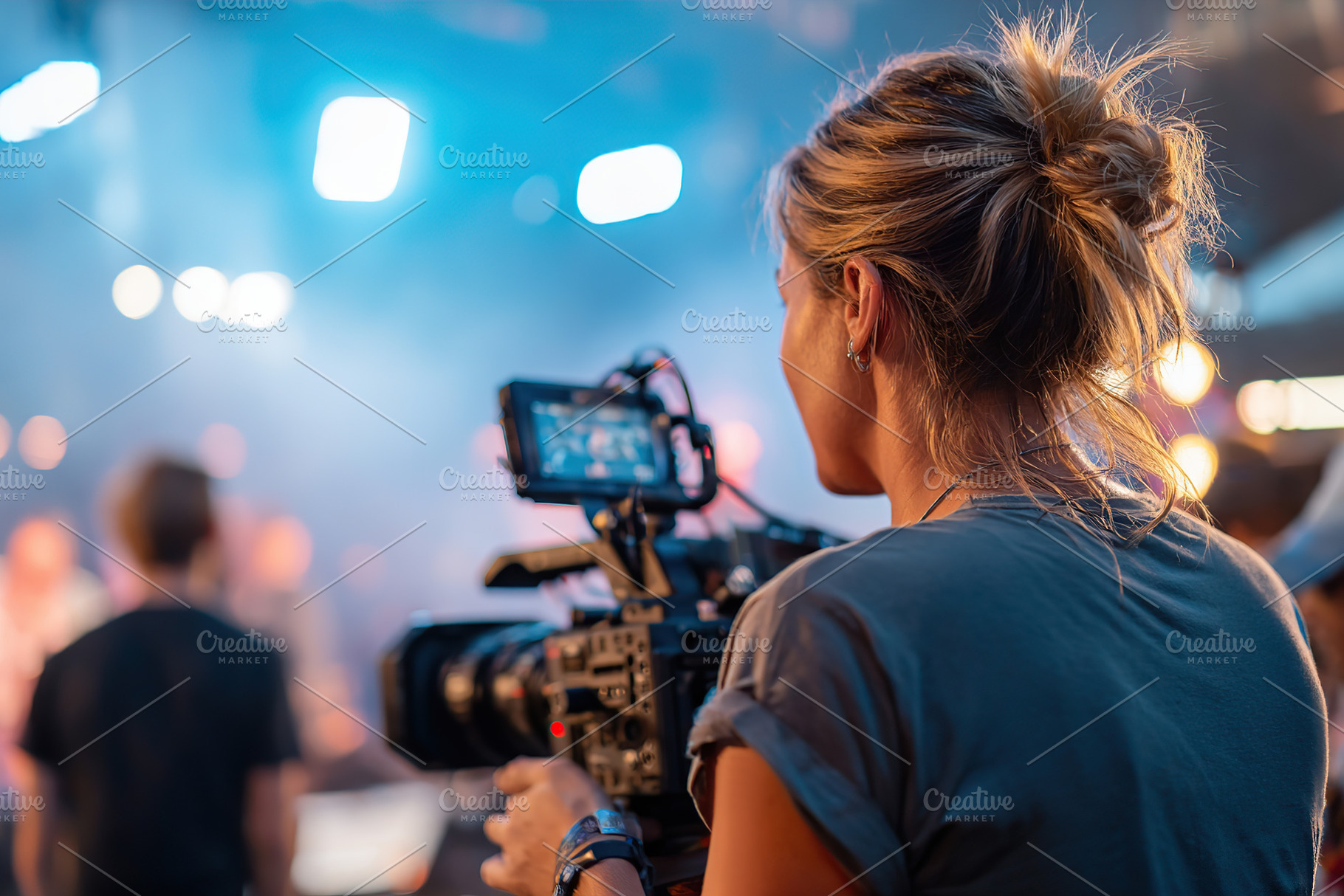 Professional cinematographer capturing footage on set during a lively productio, a Person Photo by AlyaAnd