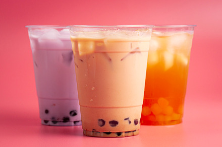 Three Different Types of Boba Tea on a Bright Pink Background