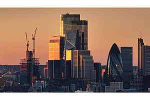 London skyline reflecting golden, an Architecture Photo by Goinyk