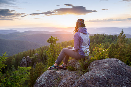 Young woman sitting on a rock looking to the horizon stock photo containing, a Sports & Recreation Photo by coob.kz