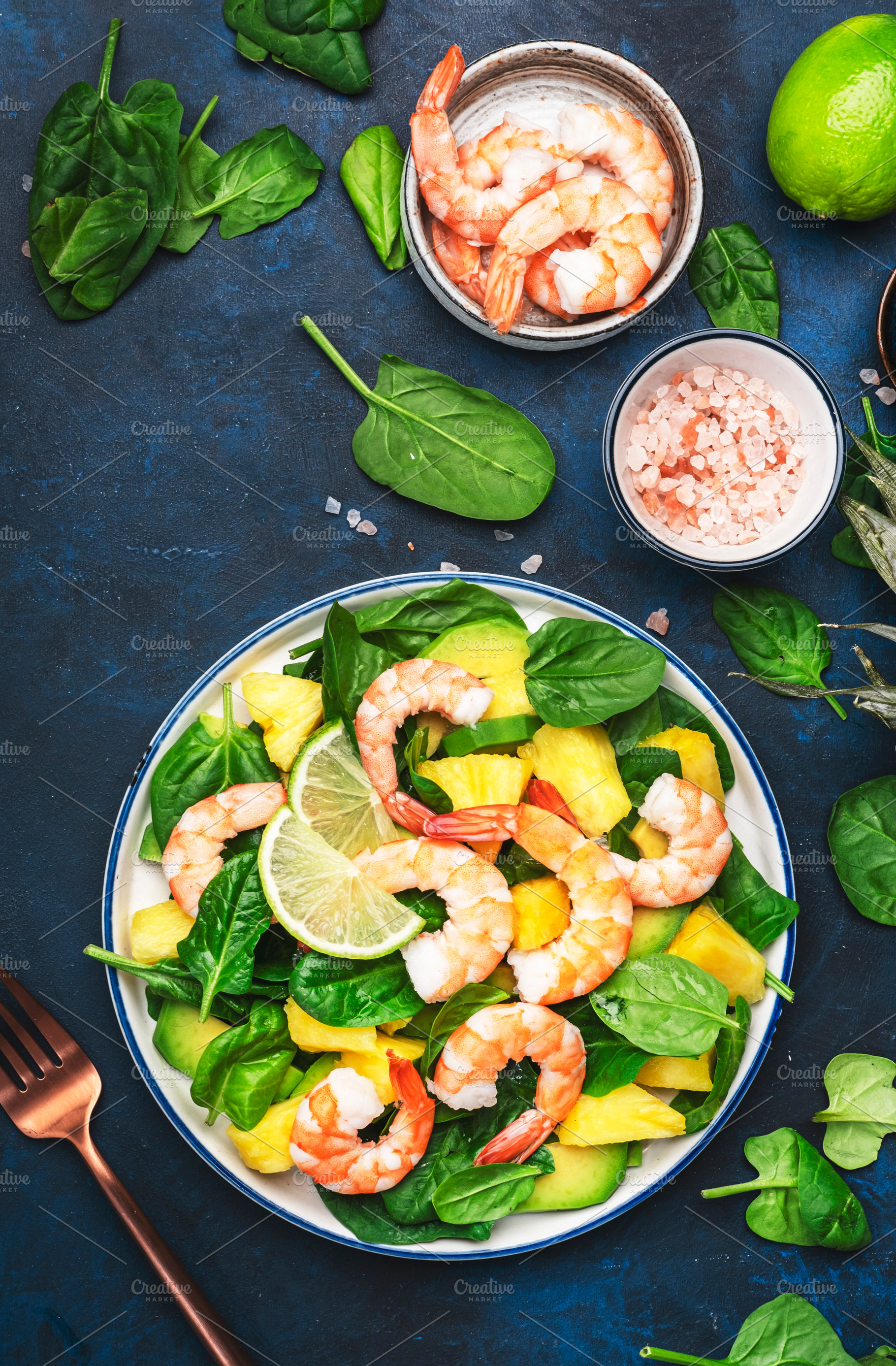 Fresh pineapple salad with shrimps, spinach, avocado and lime on, a Food & Drink Photo by 5PH