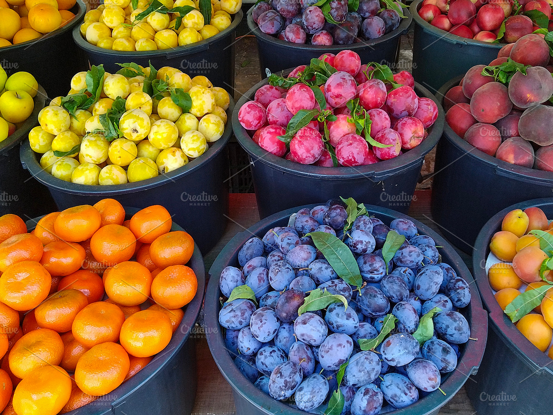Outdoor market with barrels of fresh fruit, a Food & Drink Photo by DanFLCreativo