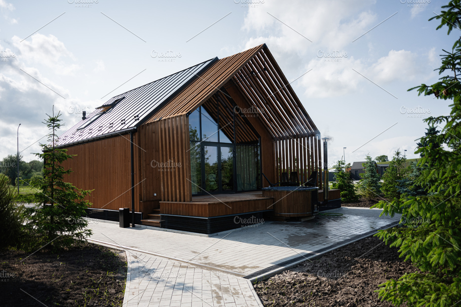 Modern wooden house with solar panels and scenic surroundings under a clear sky, a Photo by AS photostudio