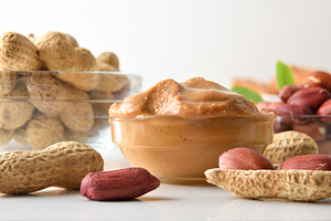 Detail of bowl full of peanut butter and fruits around, a Food & Drink Photo by Davizro's Market