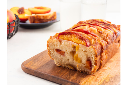 Peach cake loaf on wooden cutting
