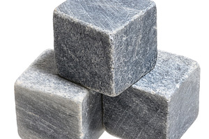 Cube of dark stone with scratches on isolated background, a Background Photo by ndanko