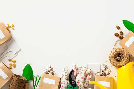 Gardeners supplies on white background. Flat lay paper bags of seeds, gardening, a Holiday Photo by photoguns