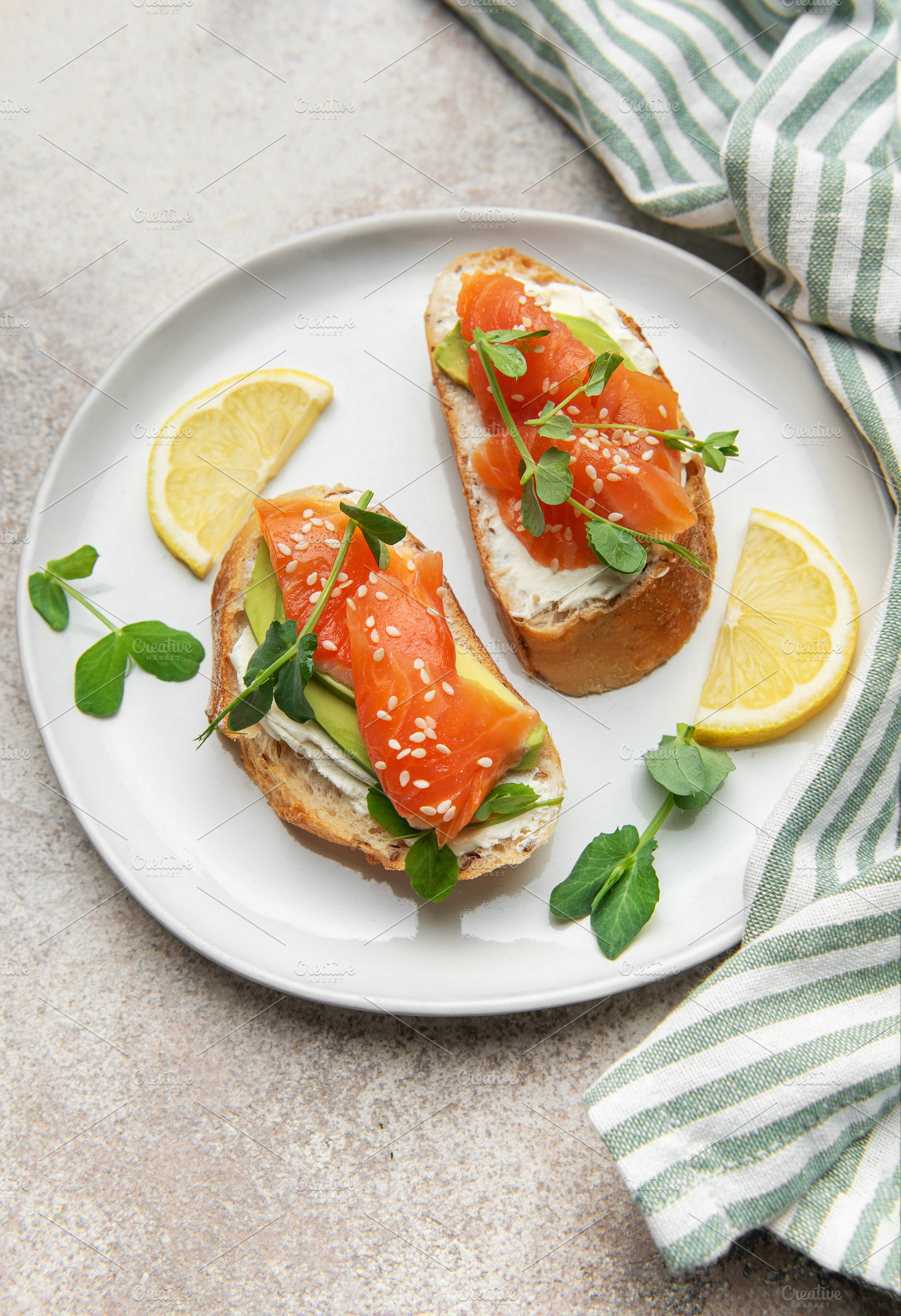 Salmon avocado toasts with cream cheese and microgreens, a Food & Drink Photo by Olena Rudo
