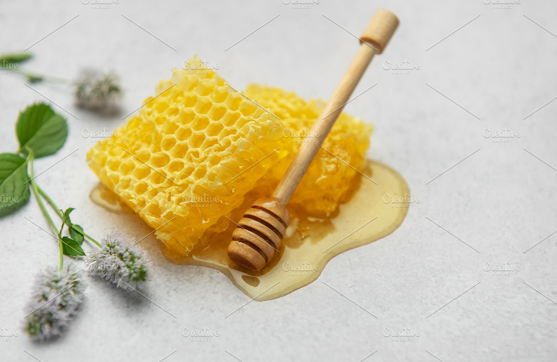 Honeycombs, honey dipper and mint flowers creating a sweet and n, a Food & Drink Photo by Olena Rudo
