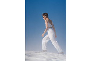 Slim blond woman walks through snow, a Beauty & Fashion Photo by Alexander-Piragis